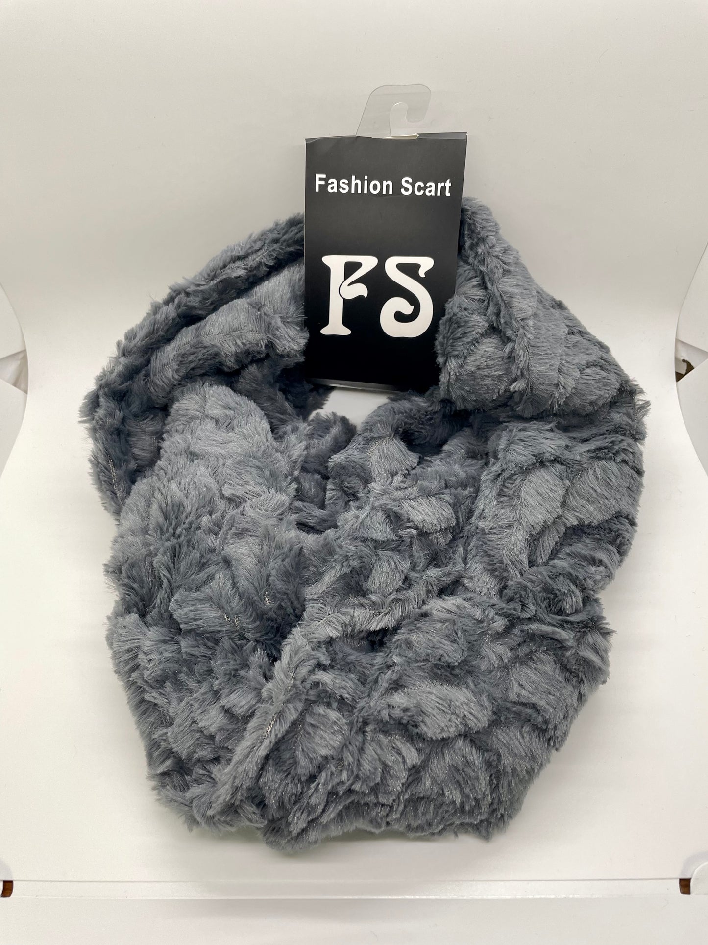 "Gray infinity scarf with a ribbed knit texture and a fringed edge"