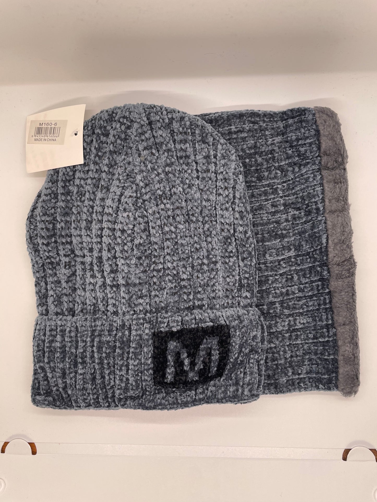 "Gray toboggan hat with neck warmer and a ribbed knit texture"