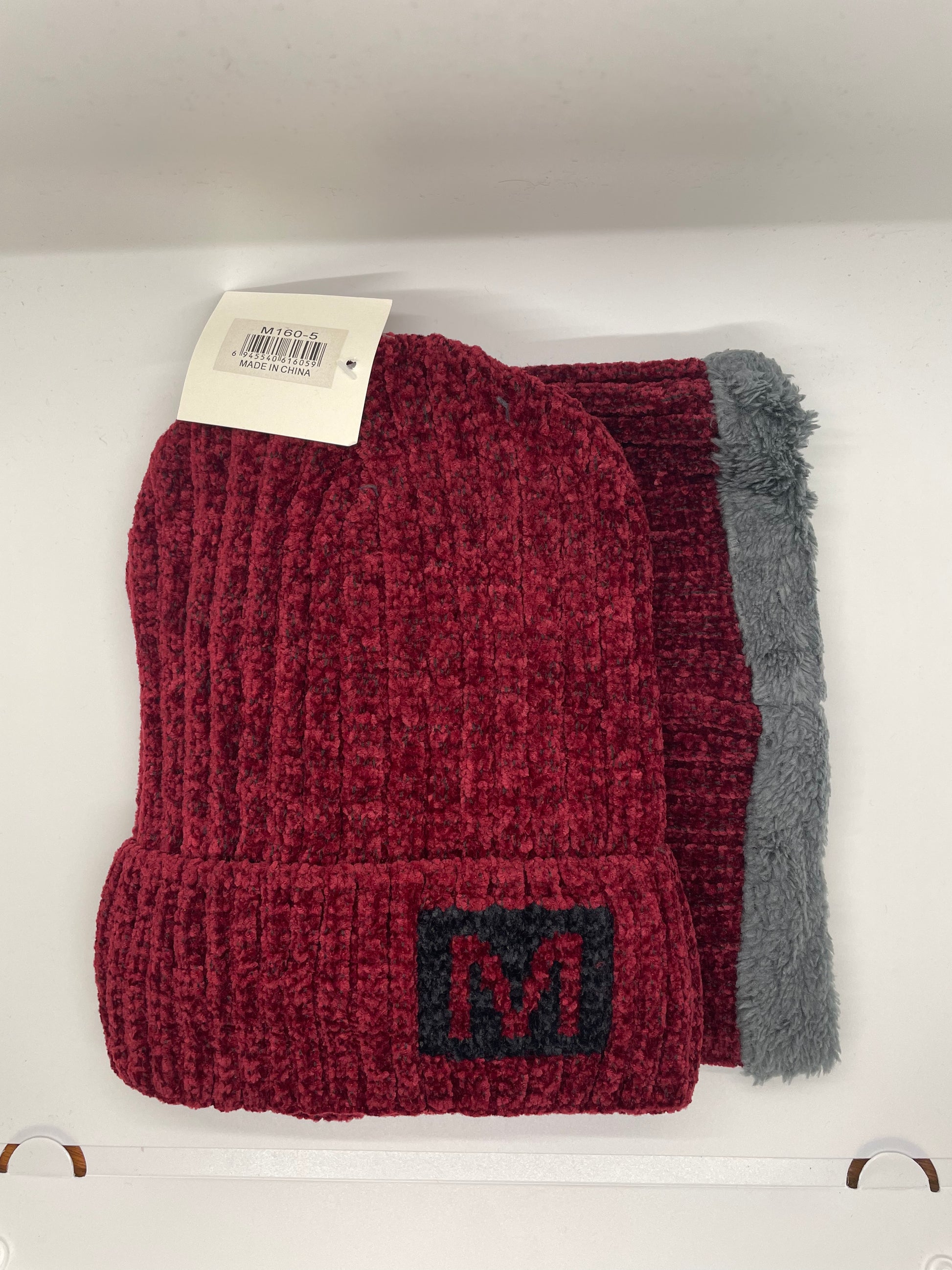 "Red toboggan hat with neck warmer and a padded headband"