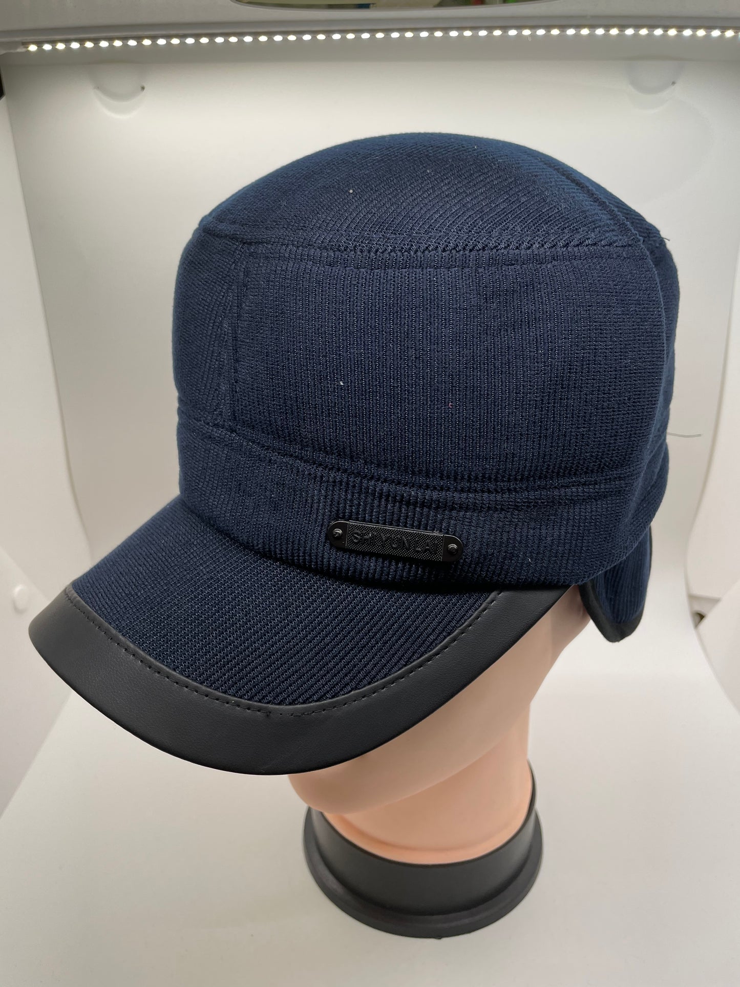 "Navy blue winter hat with ear flaps and a quilted texture"