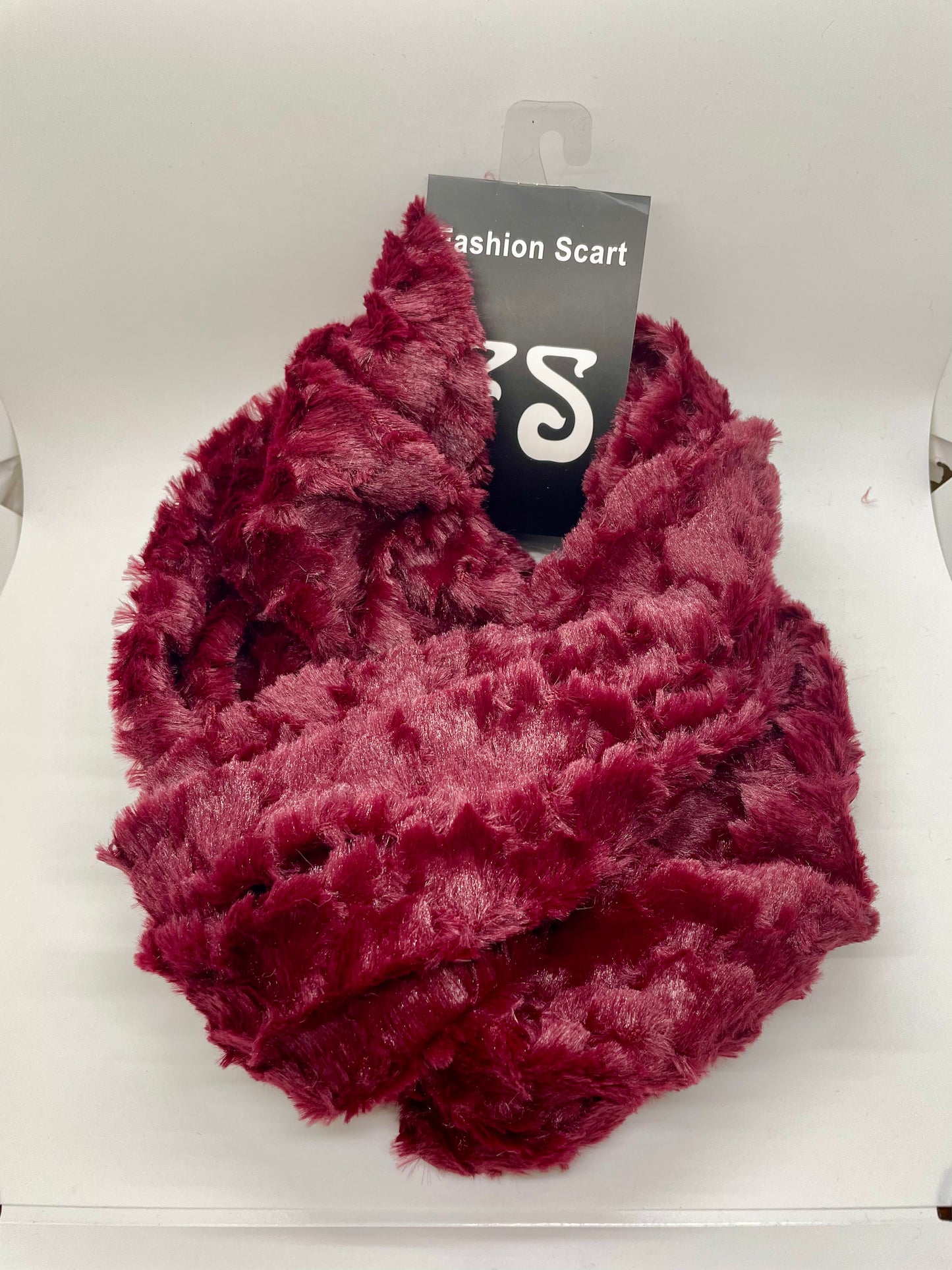"Red infinity scarf with a cable knit pattern and a roll-over edge"