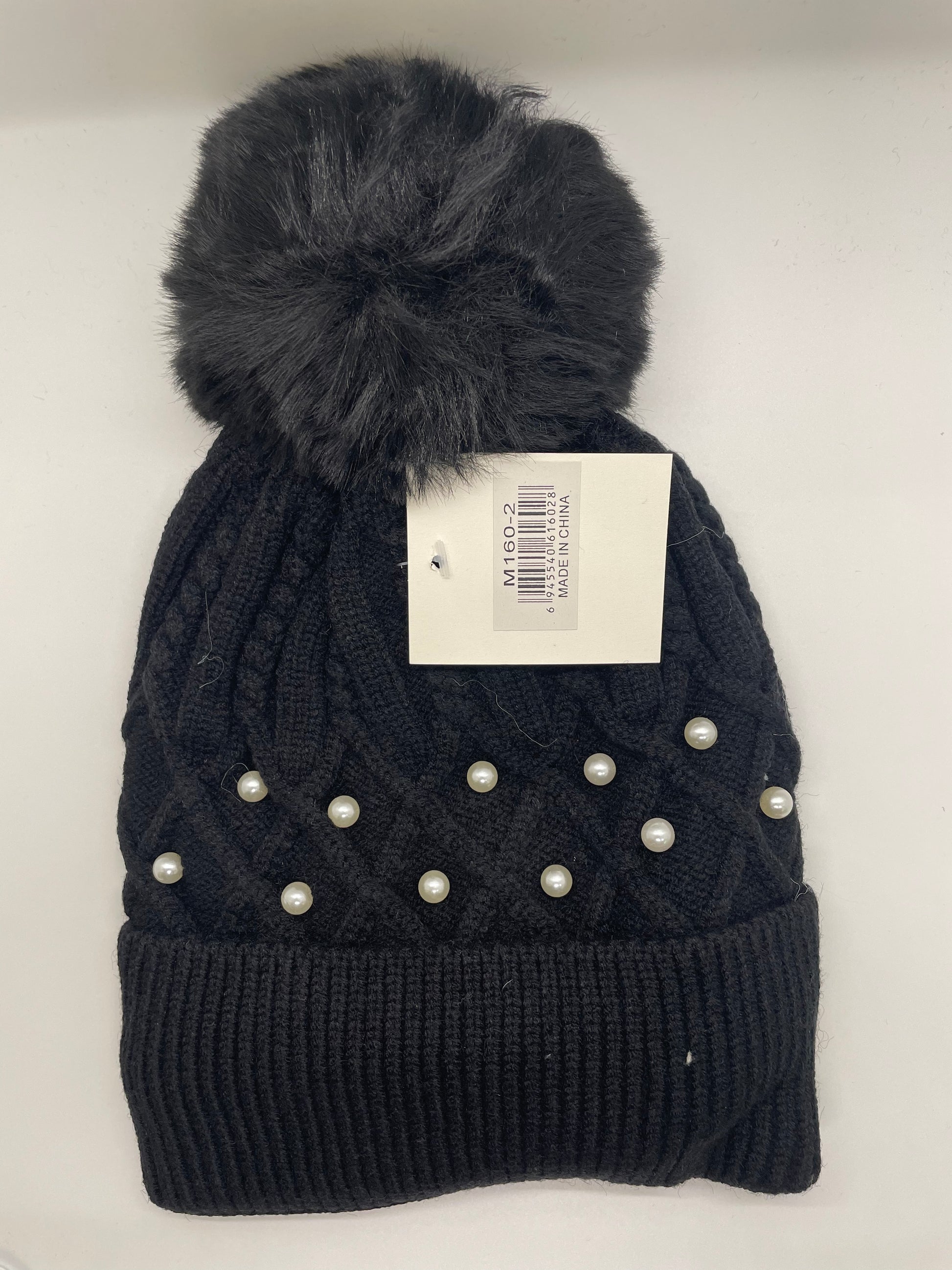 Navy blue women's toboggan hat with a quilted texture 