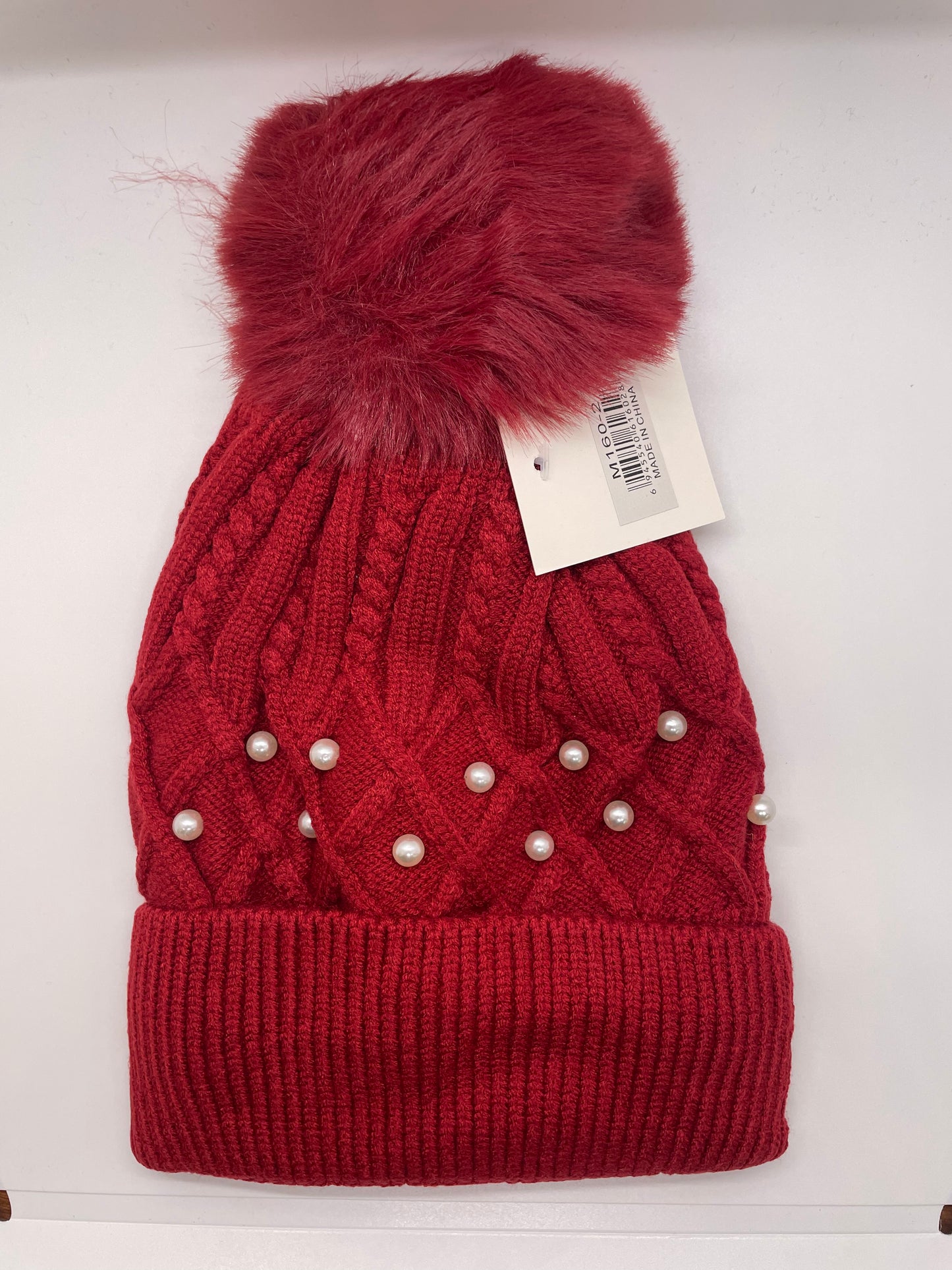 Red women's toboggan hat with a knit texture and a durable