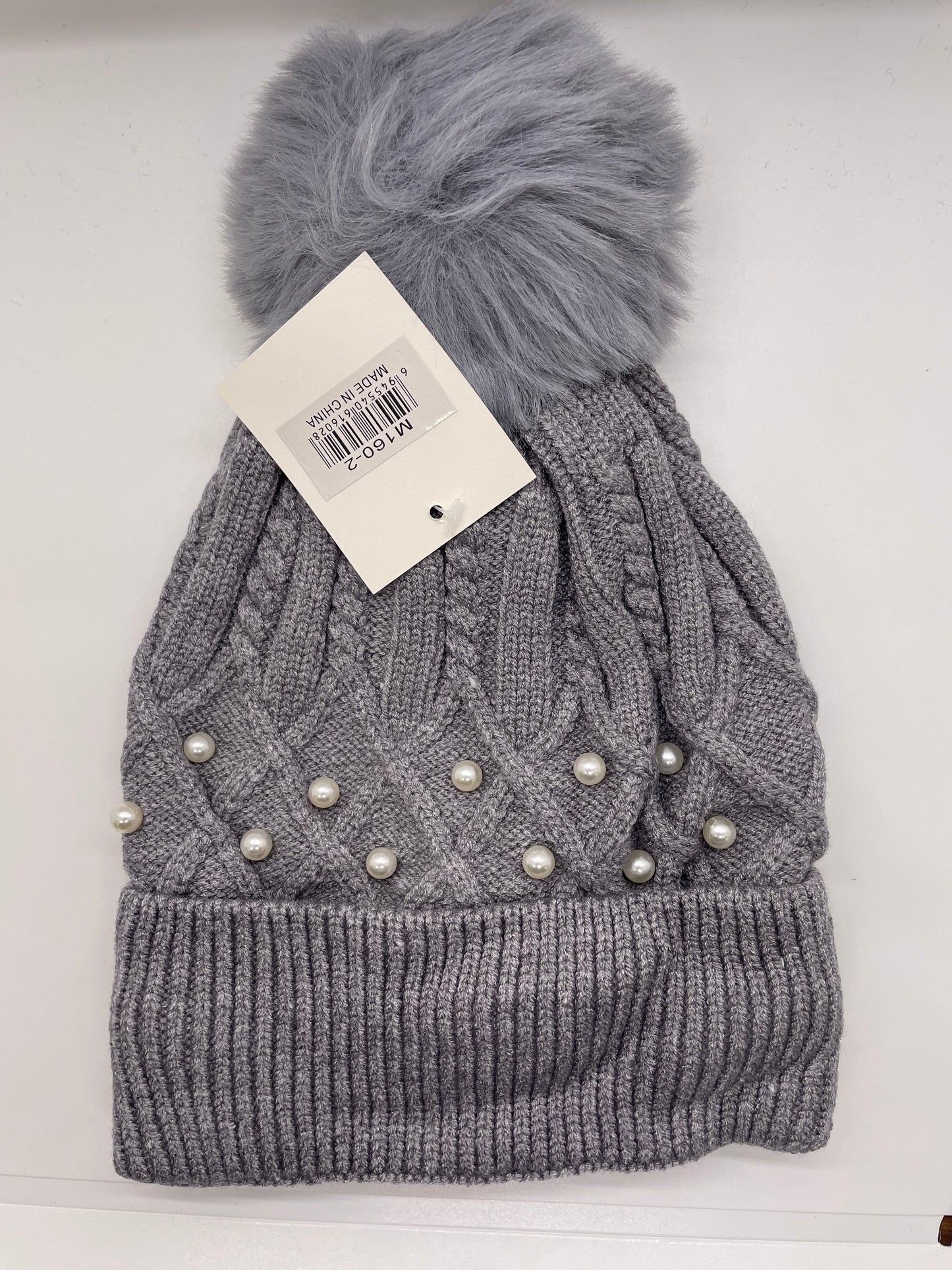 "Gray women's toboggan hat with a ribbed knit texture and a moisture-wicking design"