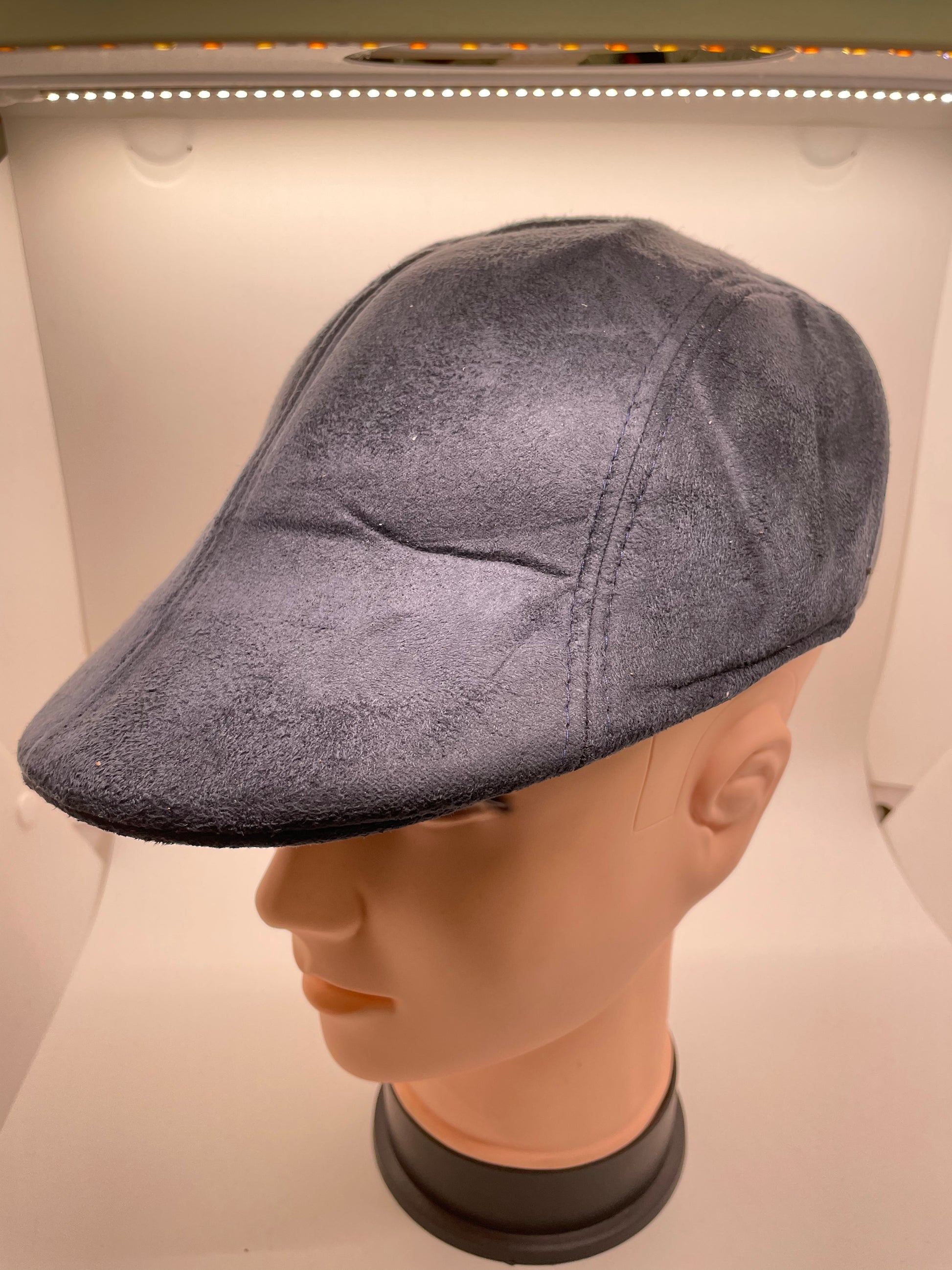 Navy blue flat hat with a quilted texture and a drawstring closure